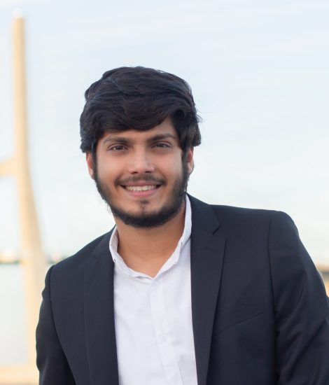 Portrait of good-looking smiling Arabic man in suit. Attractive young businessman with beard and moustache looking at camera. Portrait, international, beauty concept